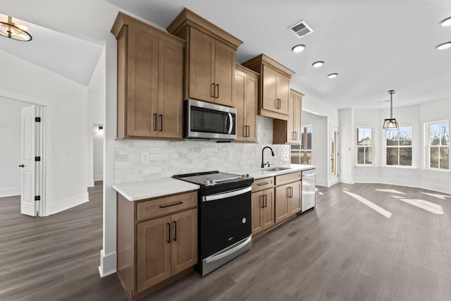 kitchen featuring electric stove, decorative backsplash, hanging light fixtures, and dark hardwood / wood-style floors