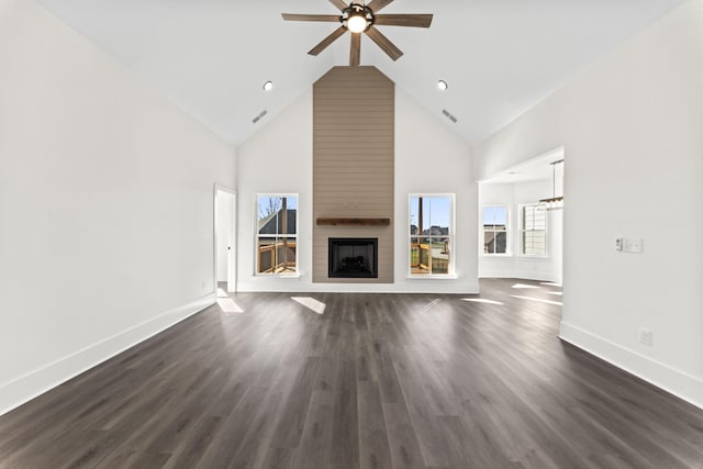 unfurnished living room with ceiling fan, a large fireplace, high vaulted ceiling, and dark hardwood / wood-style floors