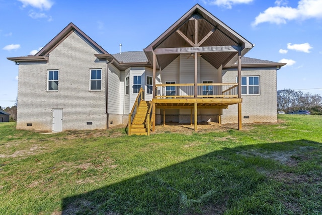 back of property with a wooden deck and a lawn