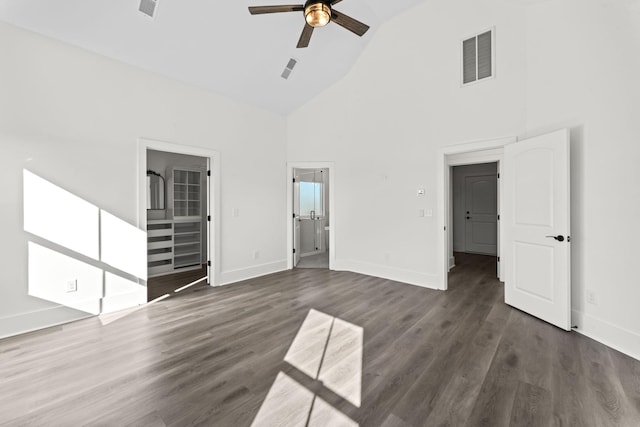 unfurnished living room featuring dark hardwood / wood-style floors, high vaulted ceiling, and ceiling fan