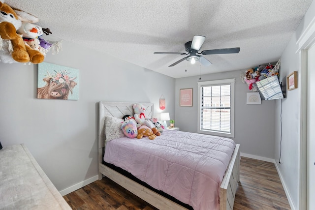 bedroom featuring a textured ceiling, ceiling fan, and dark wood-type flooring