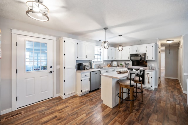 kitchen with dishwasher, a center island, decorative light fixtures, a breakfast bar area, and white cabinets