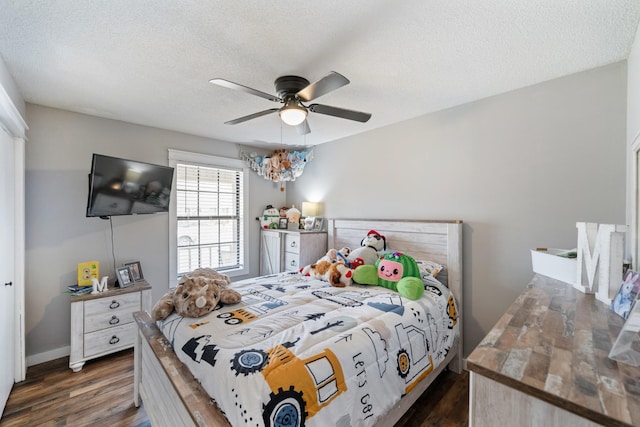 bedroom featuring a textured ceiling, dark hardwood / wood-style flooring, and ceiling fan