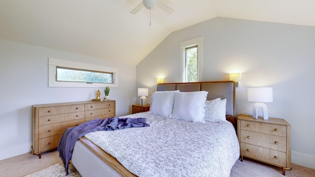 bedroom with ceiling fan, light colored carpet, and vaulted ceiling