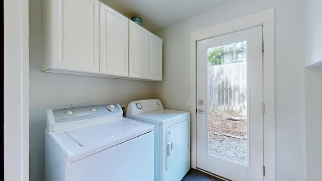 washroom featuring washer and dryer and cabinets