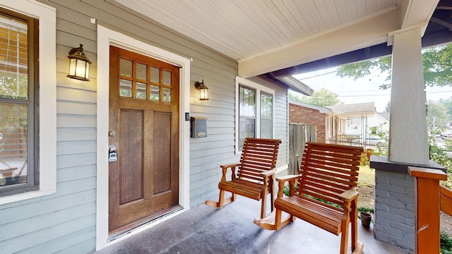 view of exterior entry with covered porch