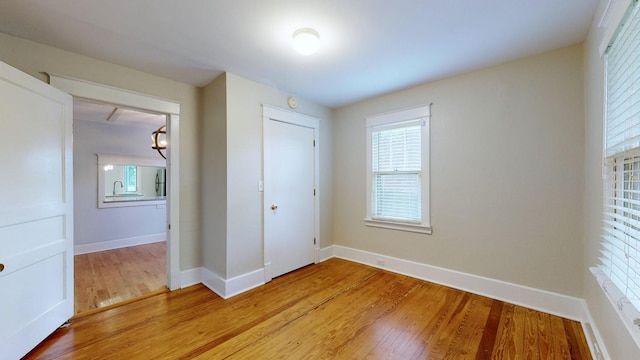 unfurnished bedroom with light hardwood / wood-style flooring and a closet