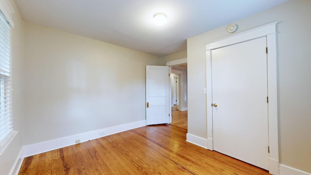 unfurnished bedroom featuring a closet and light hardwood / wood-style flooring