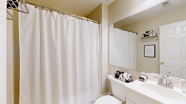 bathroom featuring vanity and toilet