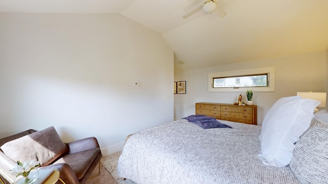 bedroom featuring ceiling fan, light colored carpet, and vaulted ceiling