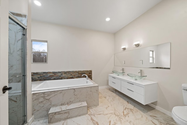 full bathroom with vanity, separate shower and tub, and toilet