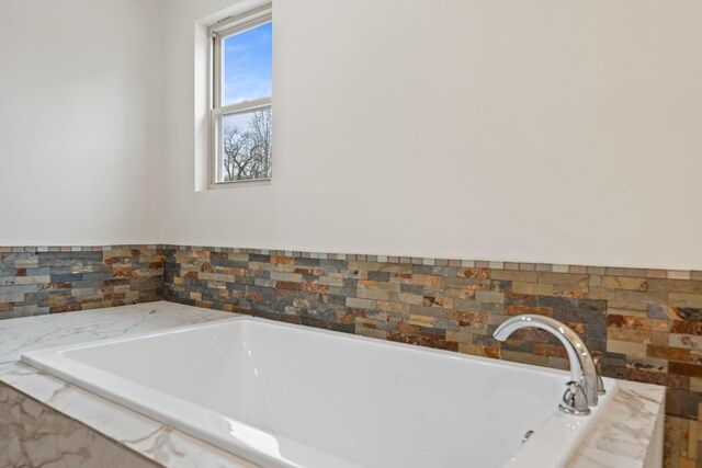 bathroom featuring tiled bath