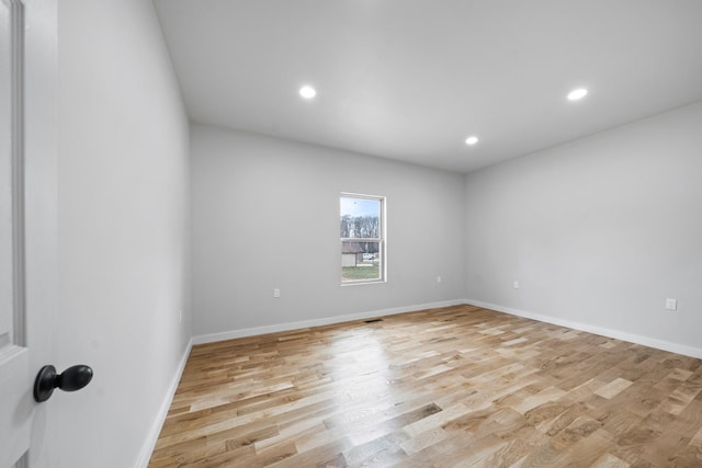 empty room with light hardwood / wood-style flooring