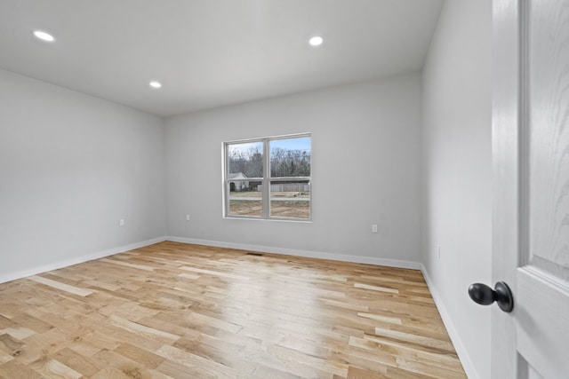 unfurnished room with light hardwood / wood-style floors