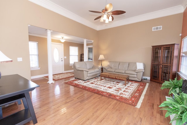 living room featuring decorative columns, crown molding, ceiling fan, and light hardwood / wood-style floors