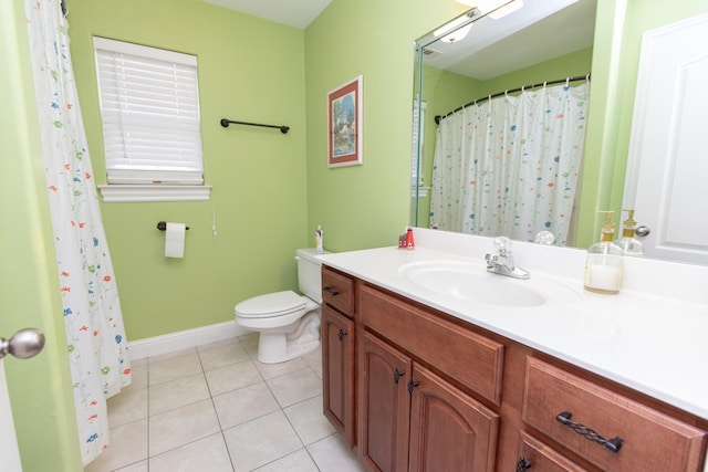 bathroom with tile patterned flooring, vanity, and toilet