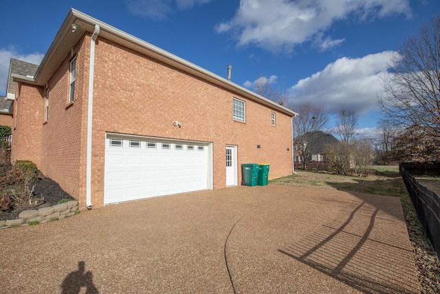 view of side of home with a garage