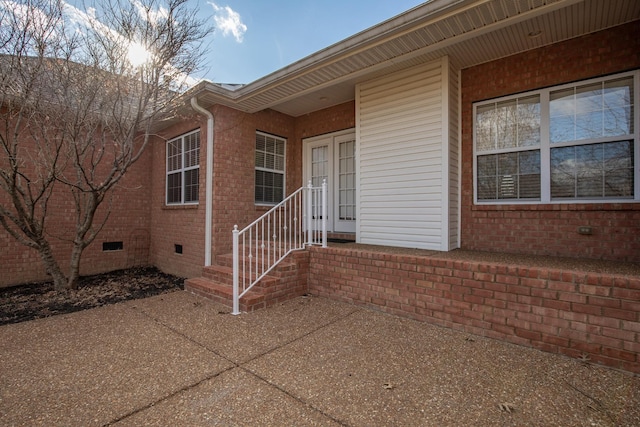 view of exterior entry featuring a patio