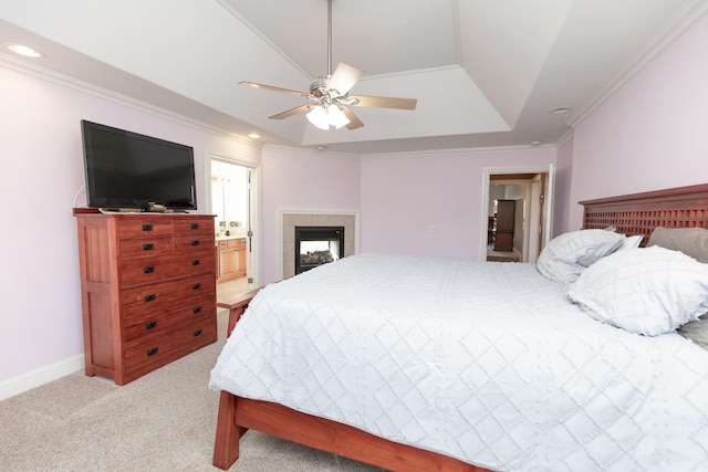 bedroom with ensuite bathroom, a multi sided fireplace, ceiling fan, ornamental molding, and light colored carpet