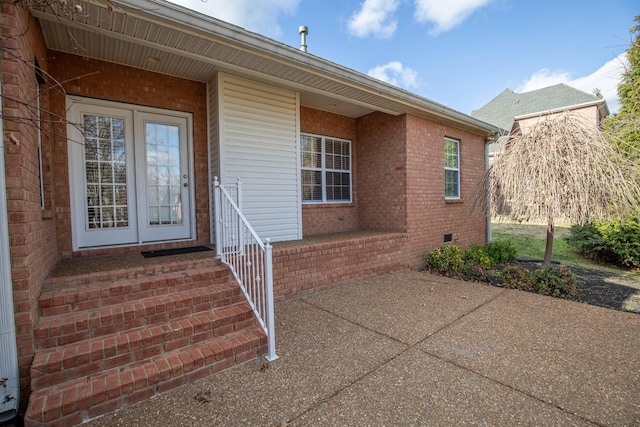 entrance to property featuring french doors and a patio