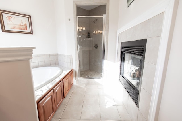 bathroom with tile patterned flooring and separate shower and tub