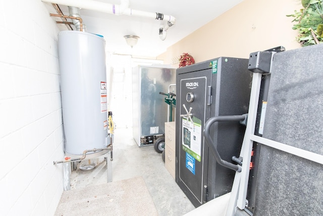 utility room featuring water heater