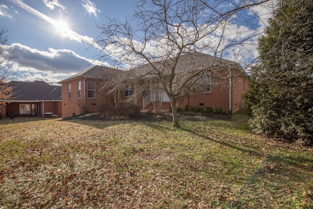 rear view of property with a yard