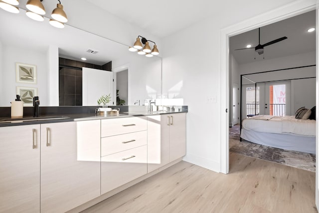 bathroom with ceiling fan, french doors, walk in shower, wood-type flooring, and vanity