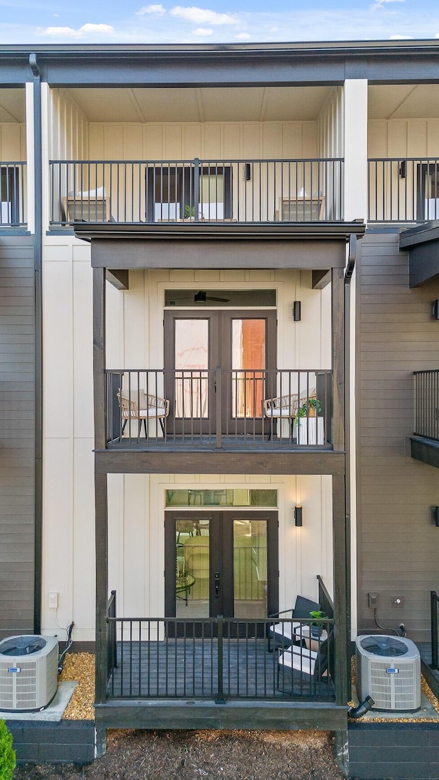 back of property with a balcony and french doors