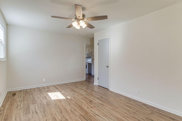 empty room with light hardwood / wood-style flooring and ceiling fan