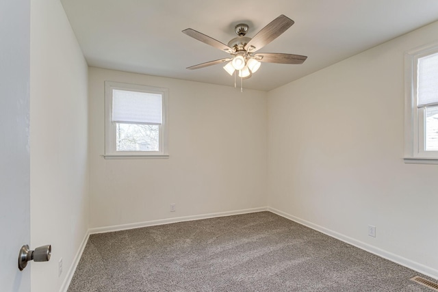 carpeted spare room with ceiling fan