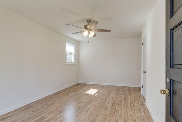 empty room with ceiling fan and light hardwood / wood-style floors