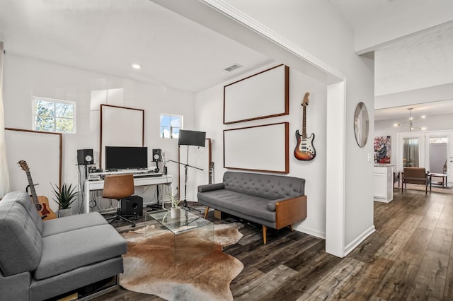 living room featuring dark hardwood / wood-style flooring and a chandelier