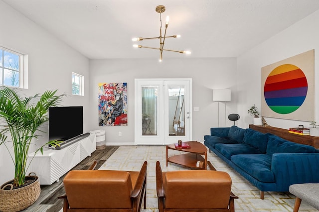 living room with wood-type flooring and an inviting chandelier