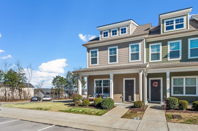 view of front of property with a front yard and a porch