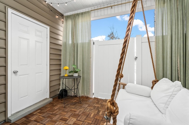 interior space featuring dark parquet floors and wood walls