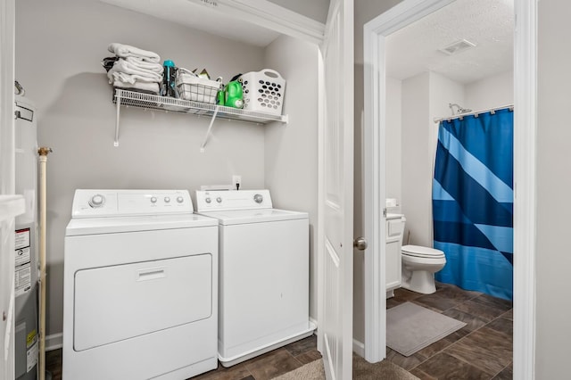 washroom with washer and dryer and a textured ceiling