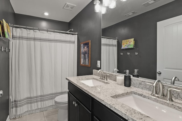 bathroom with tile patterned flooring, vanity, and toilet