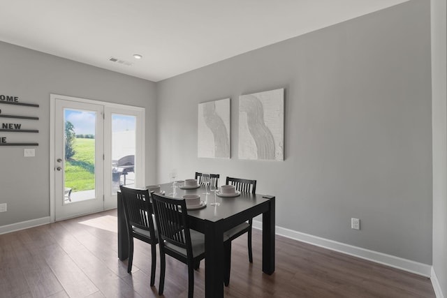 dining area with dark hardwood / wood-style flooring