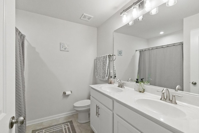 bathroom featuring vanity, curtained shower, tile patterned floors, and toilet