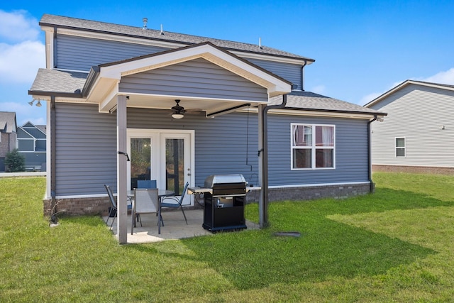 back of property with a patio, a yard, and ceiling fan