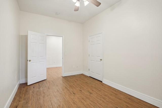 spare room with light hardwood / wood-style floors and ceiling fan