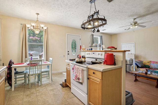 kitchen featuring a textured ceiling, ceiling fan with notable chandelier, pendant lighting, and electric stove