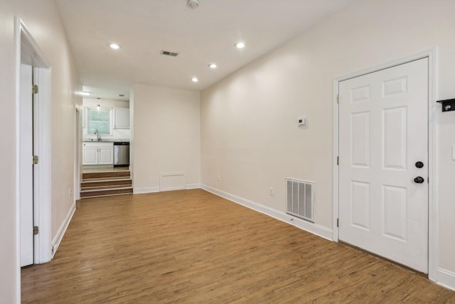 unfurnished room with sink and wood-type flooring