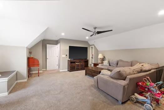 carpeted living room featuring ceiling fan and vaulted ceiling