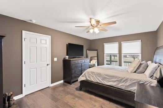 bedroom with ceiling fan and dark wood-type flooring