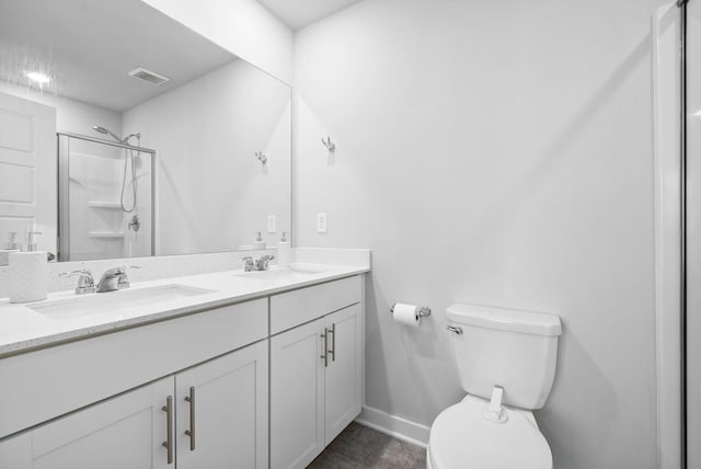 bathroom featuring vanity, toilet, and walk in shower