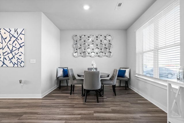 dining space with dark wood-type flooring