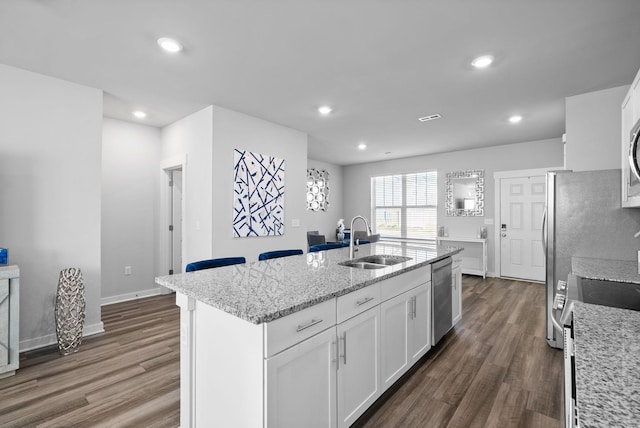 kitchen featuring white cabinetry, sink, an island with sink, and stainless steel appliances