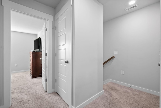 corridor featuring light colored carpet